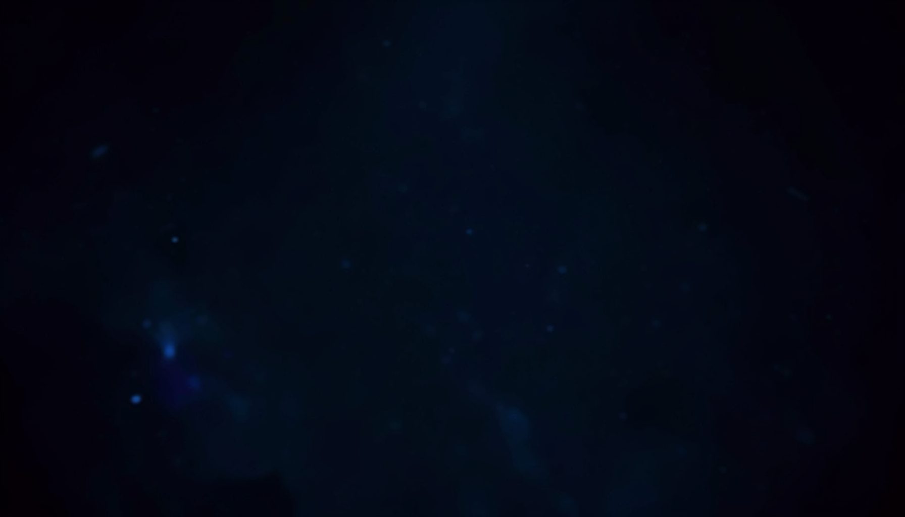Dark atmospheric backdrop with deep navy and charcoal tones, subtle glowing highlights in cool blue, evoking an energetic digital gaming ambiance