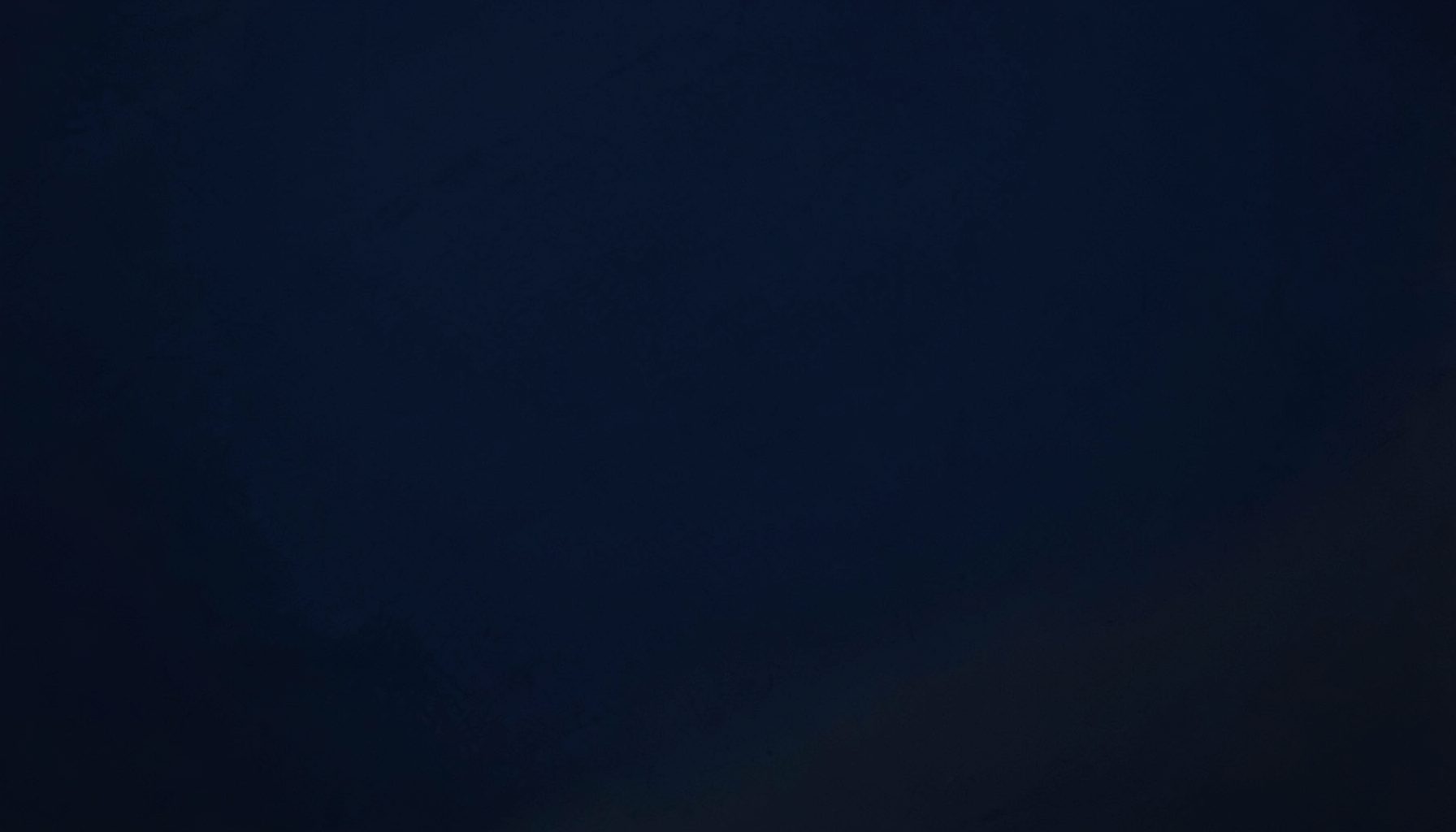 Deep navy and charcoal abstract texture with subtle gradient transitions, providing a rich dark foundation for footer content